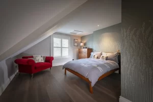 full height plantation shutters in white installed in a bed room in Winchester by The Great Shutter Co.